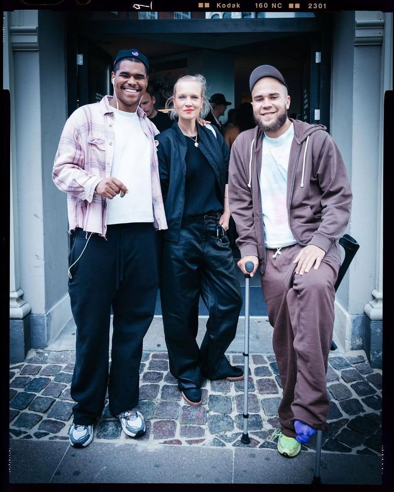 Three guests pose together outside at the Timberland × Rezet evening event.