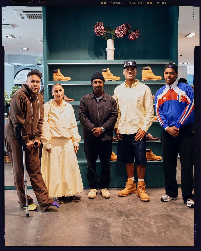 Group photo inside Rezet Store after the Timberland breakfast panel talk, with Timberland boots on the shelves behind.